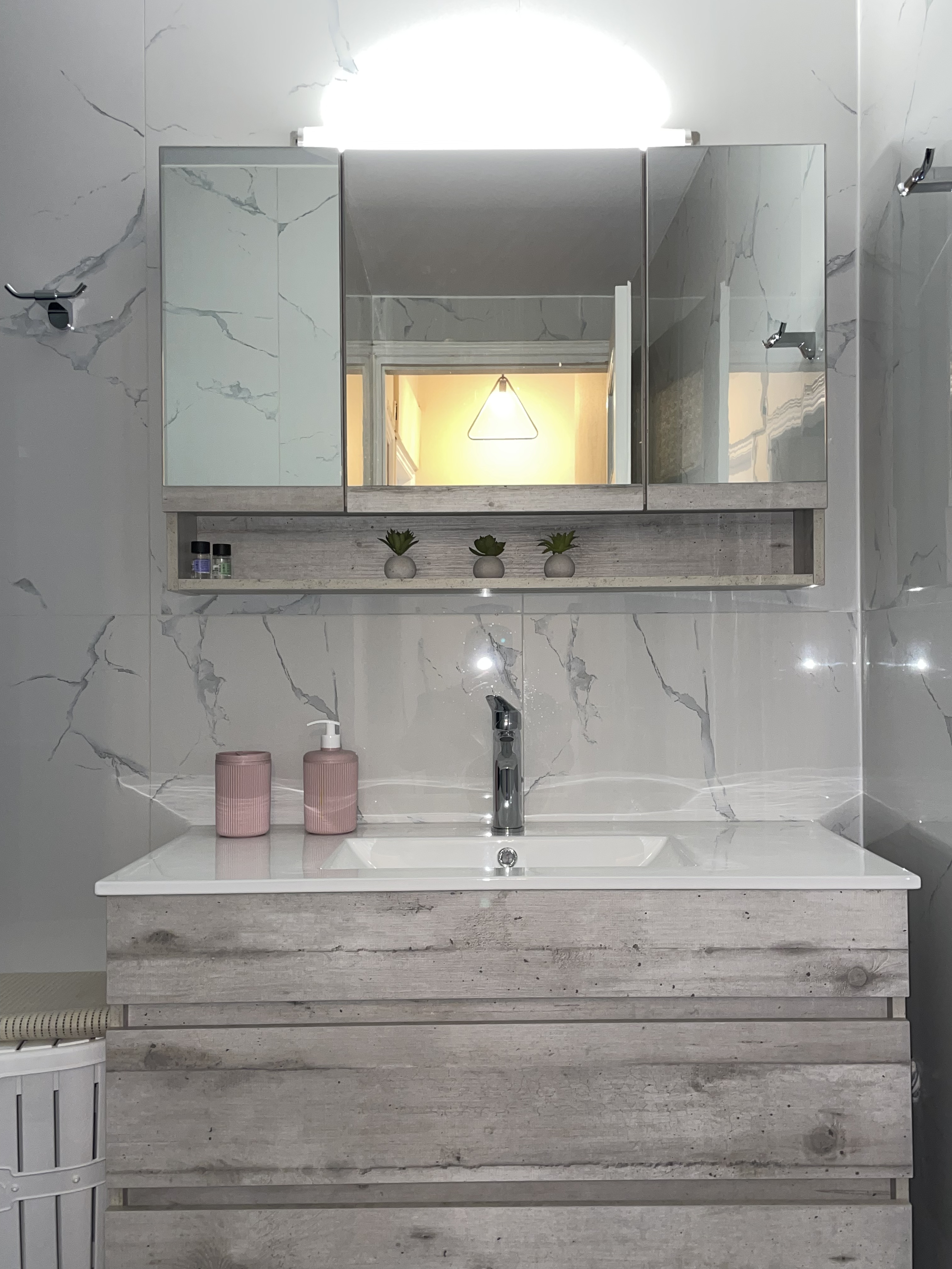 Modern marble bathroom with vanity and warm lighting