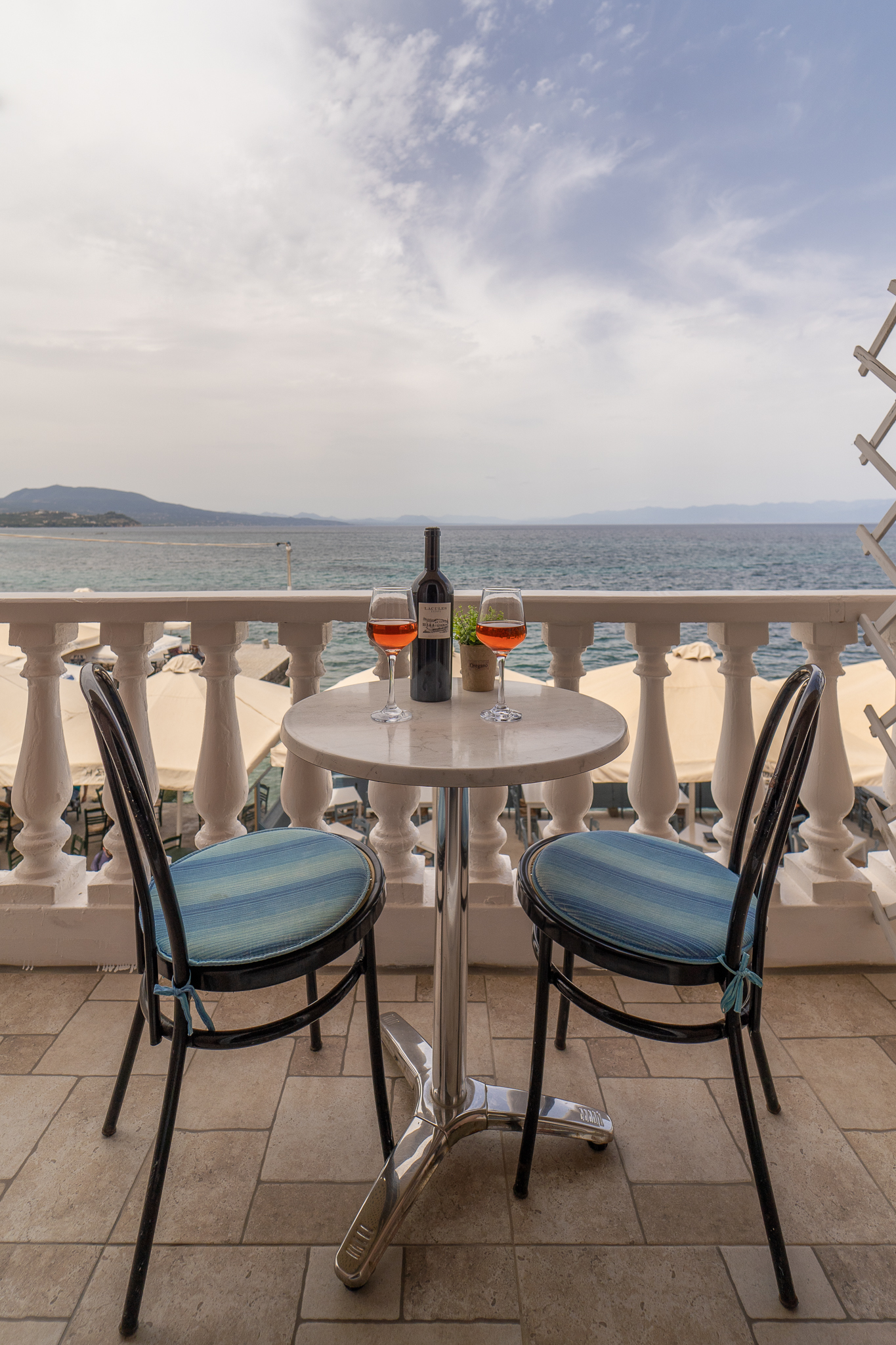 Balcony table with wine and panoramic sea view