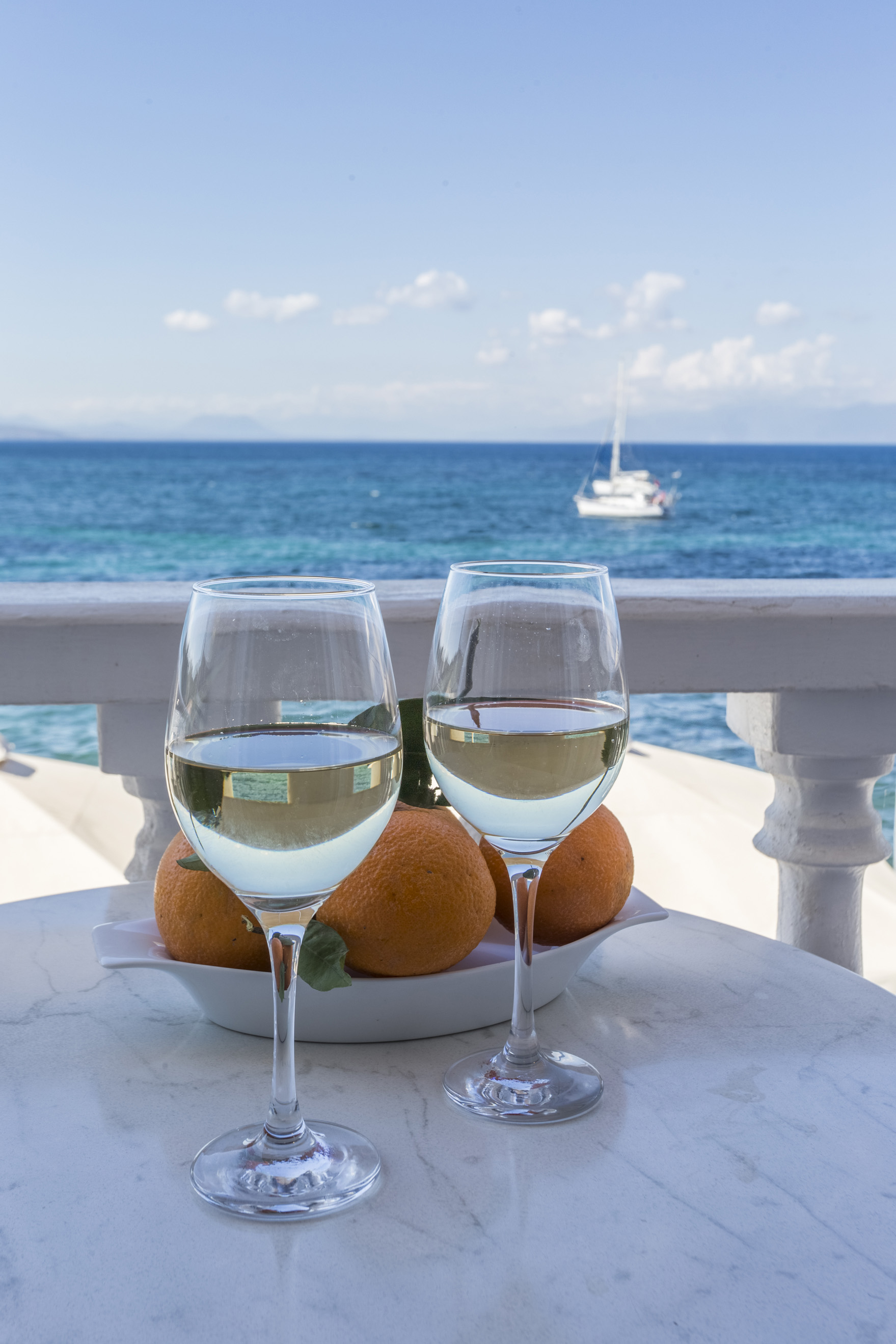 Wine glasses on the sea-view balcony at Parthenon Rooms, Koroni