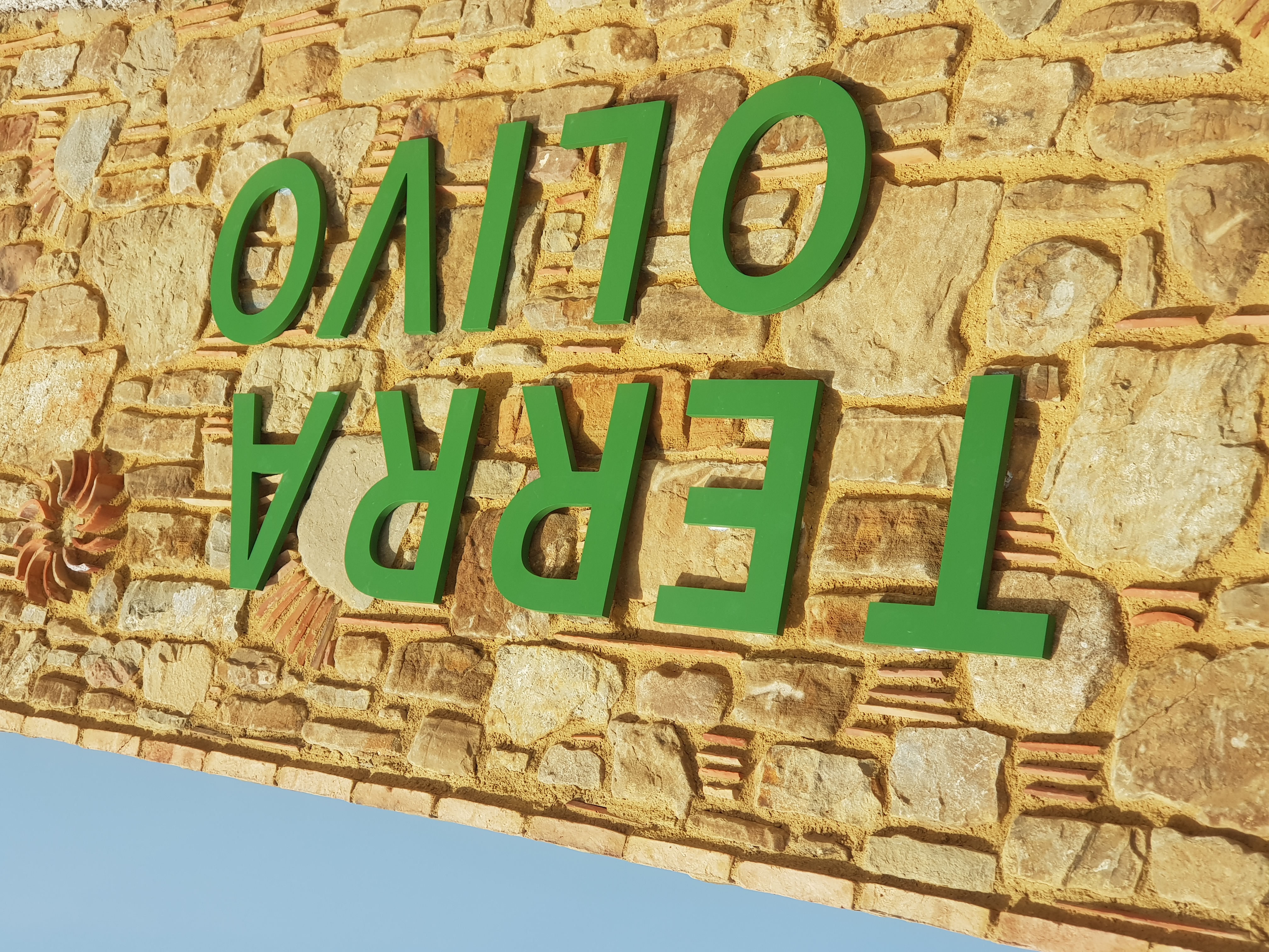 Terra Olivo sign on stone wall